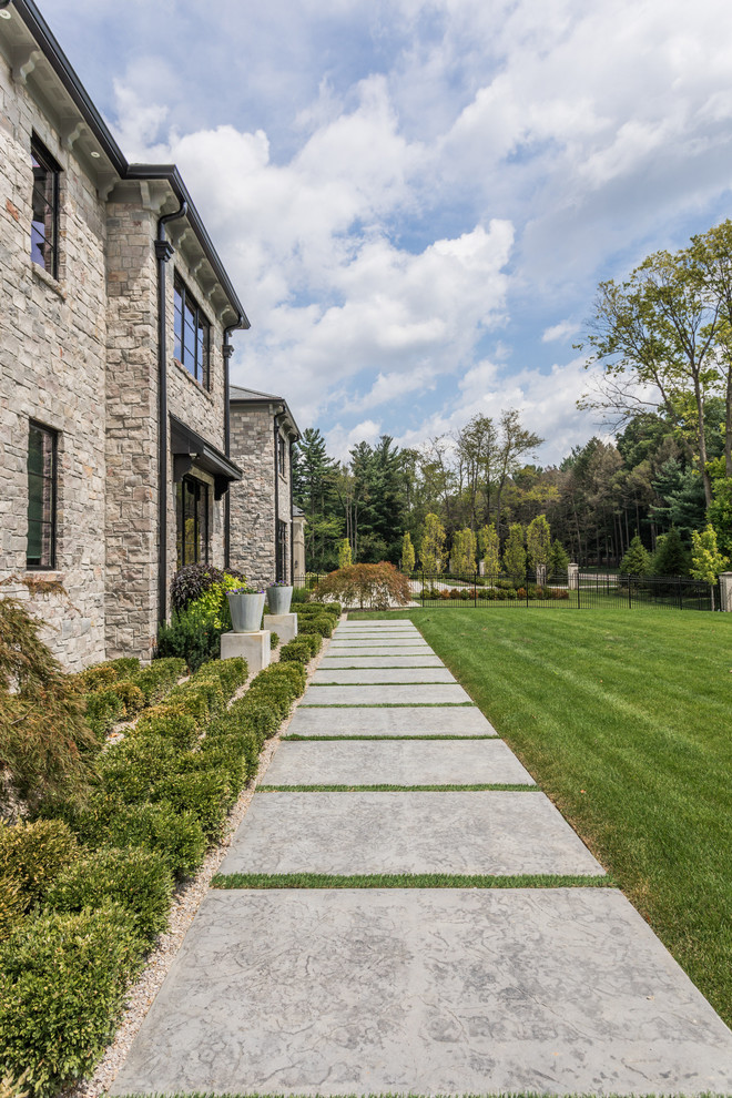 Large tuscan multicolored two-story stone house exterior photo in Indianapolis