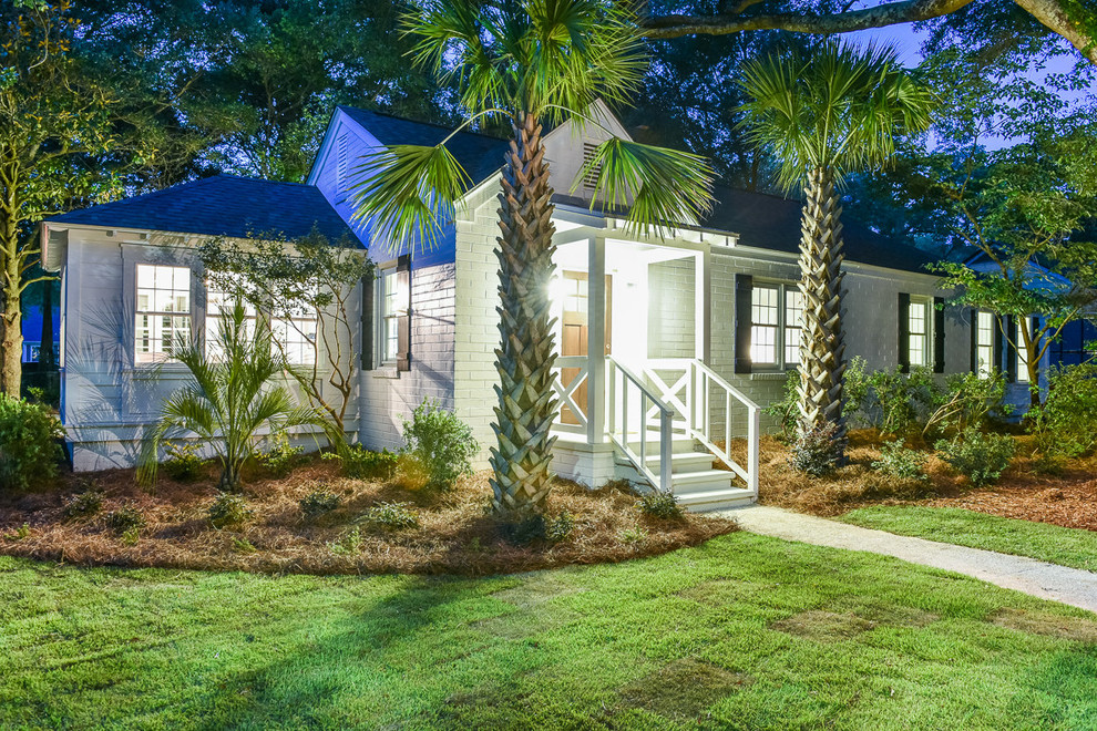 Example of a mid-sized classic white one-story vinyl gable roof design in Charleston