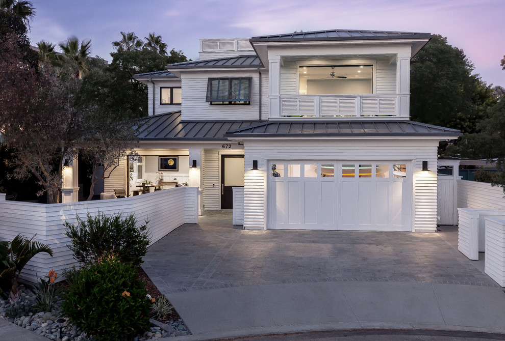 Country white two-story concrete fiberboard house exterior photo in San Diego with a hip roof and a metal roof
