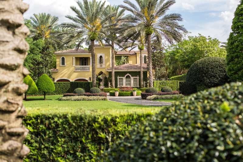 Inspiration for an expansive and yellow mediterranean two floor render house exterior in Orlando with a hip roof.
