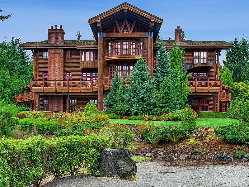 Photo of an expansive and brown rustic two floor house exterior in Seattle with wood cladding.