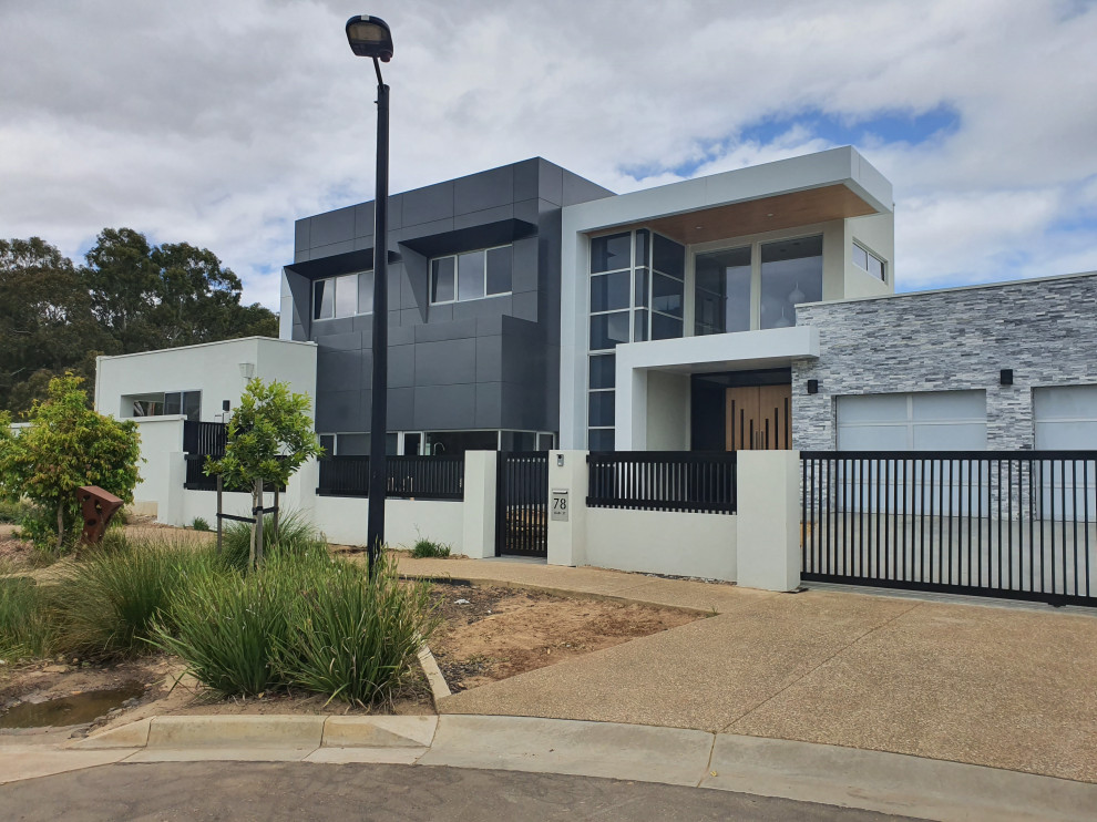 Inspiration for an expansive and multi-coloured contemporary two floor detached house in Adelaide with mixed cladding and a flat roof.