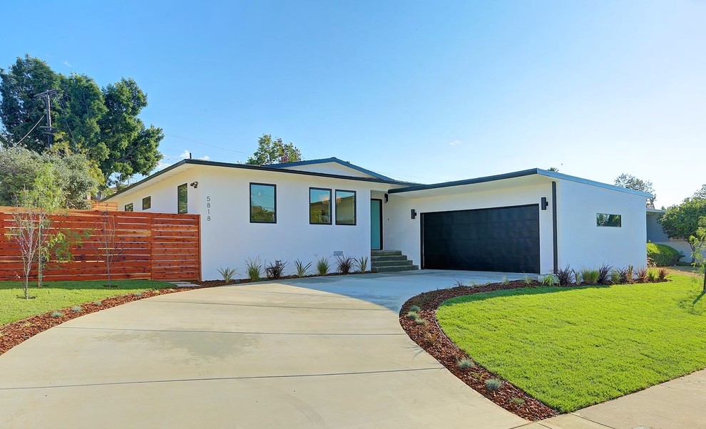 This is an example of a medium sized and white retro bungalow render house exterior in Los Angeles.
