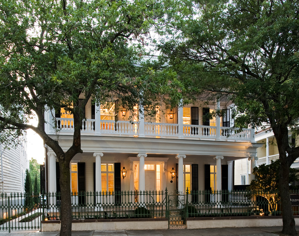 Large and white traditional two floor house exterior in Charleston with wood cladding.