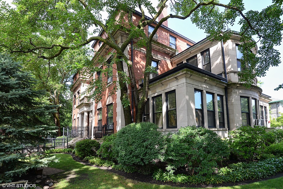 Example of a huge classic three-story exterior home design in Chicago