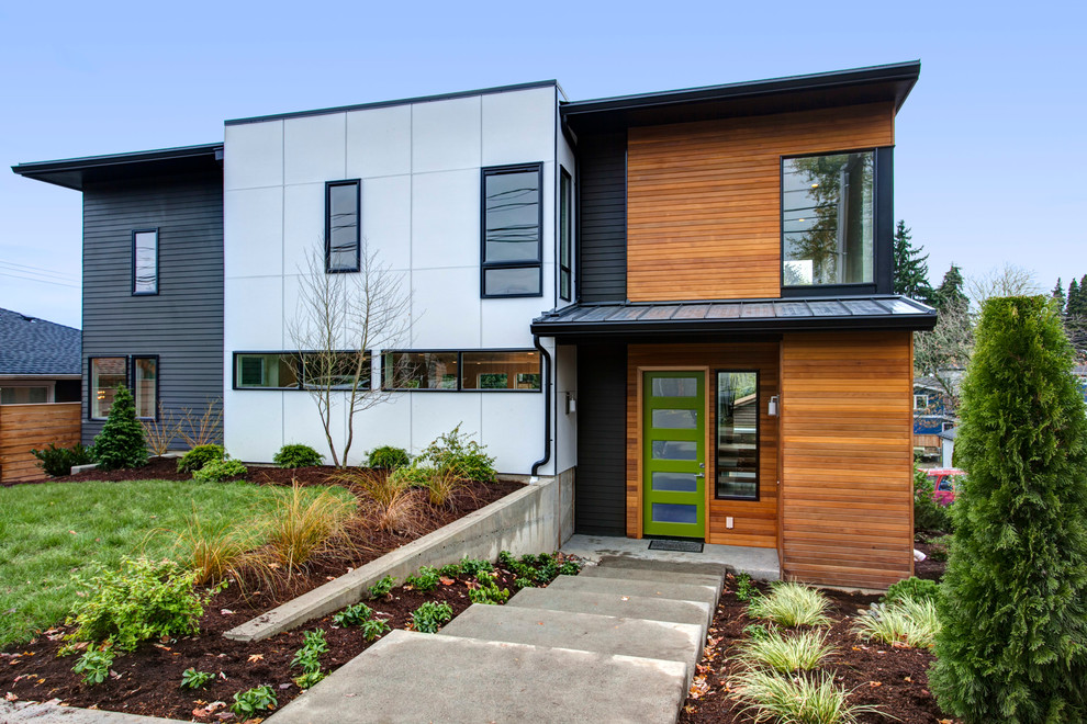 Diseño de fachada gris contemporánea de tamaño medio de tres plantas con revestimiento de aglomerado de cemento y tejado plano