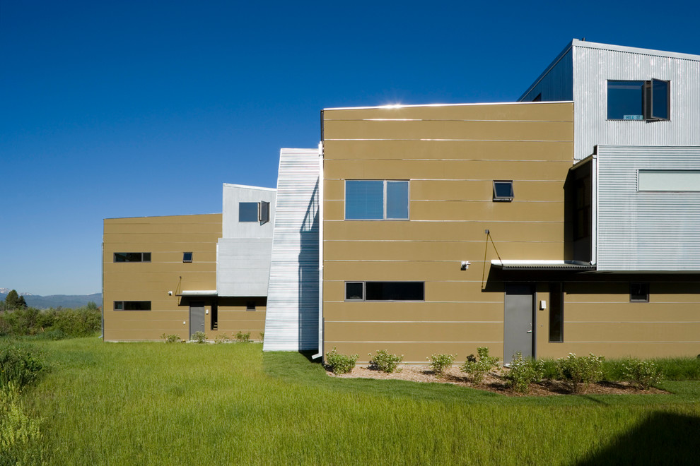 Dreistöckiges, Geräumiges Modernes Reihenhaus mit Mix-Fassade, grauer Fassadenfarbe, Flachdach und Blechdach in Sonstige