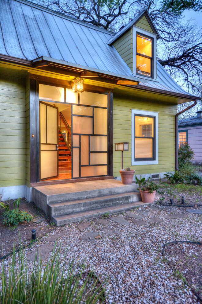 Example of an eclectic green two-story wood exterior home design in Austin