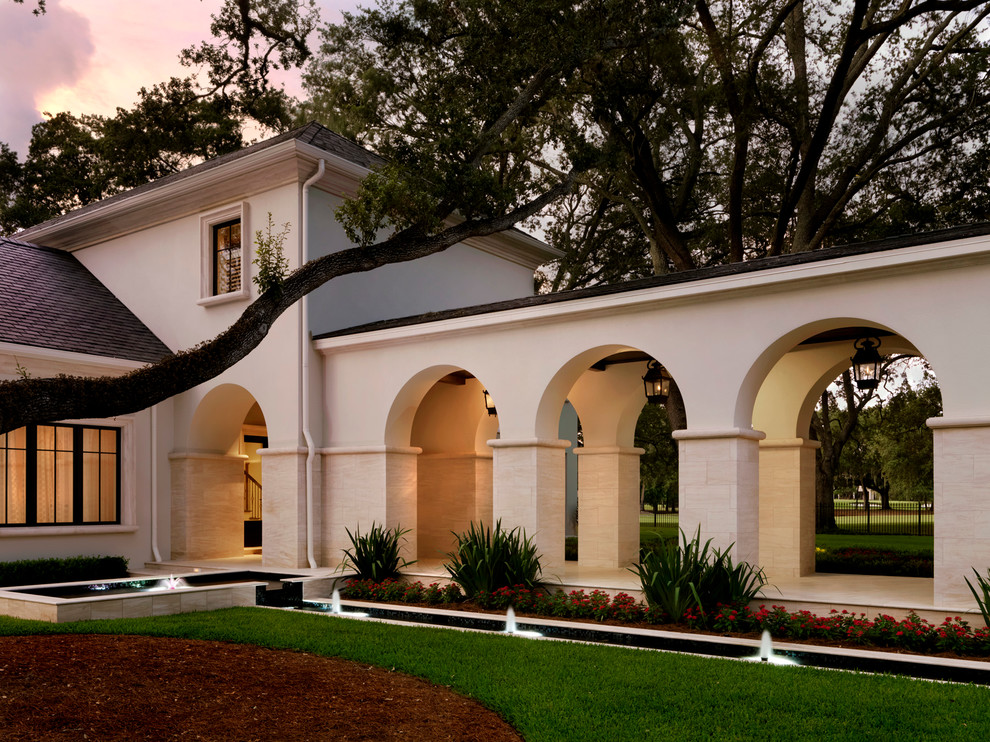 Inspiration for a huge timeless two-story stucco exterior home remodel in Tampa