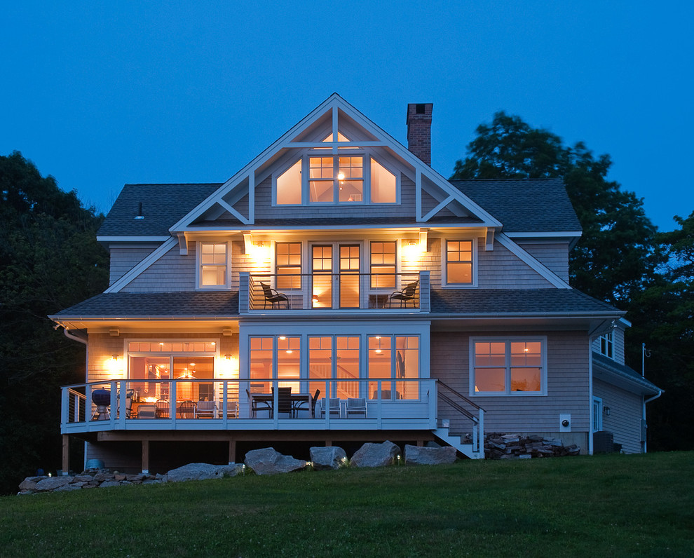 This is an example of a large and gey beach style detached house in Bridgeport with three floors, a pitched roof, wood cladding and a shingle roof.