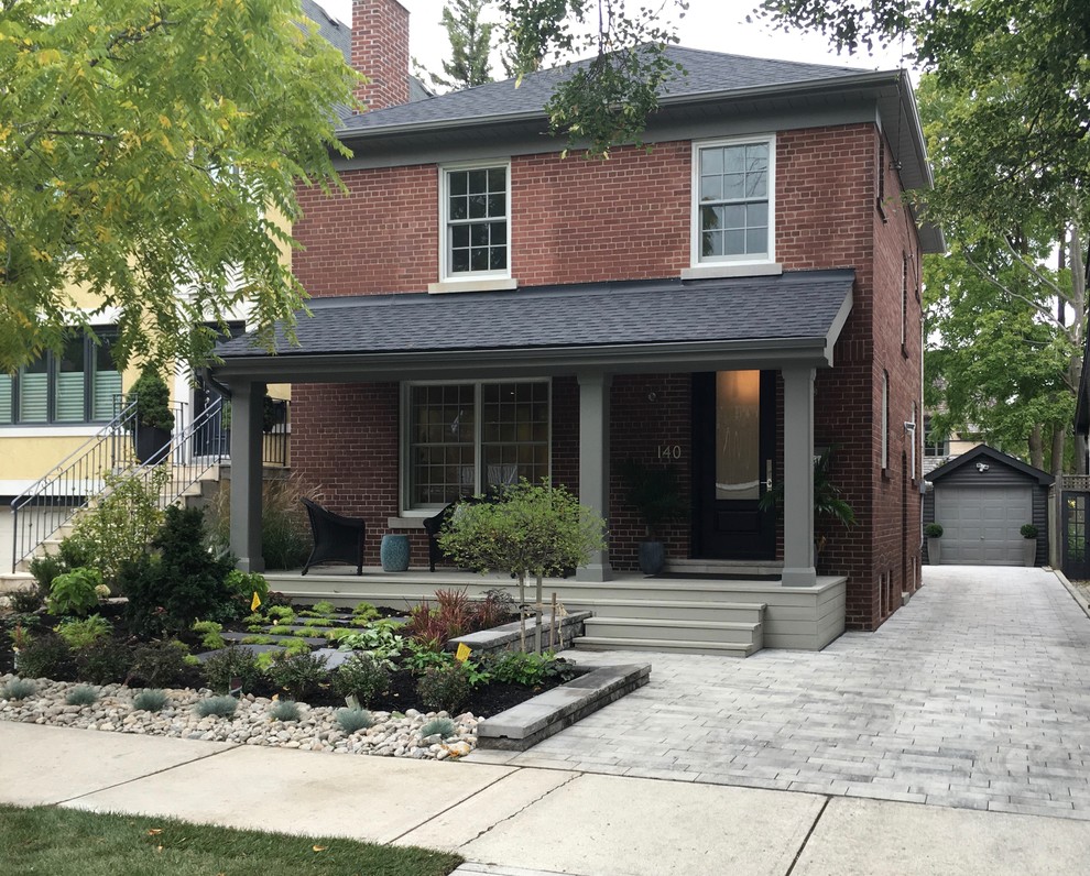 Design ideas for a medium sized and red classic two floor brick house exterior in Toronto with a hip roof.
