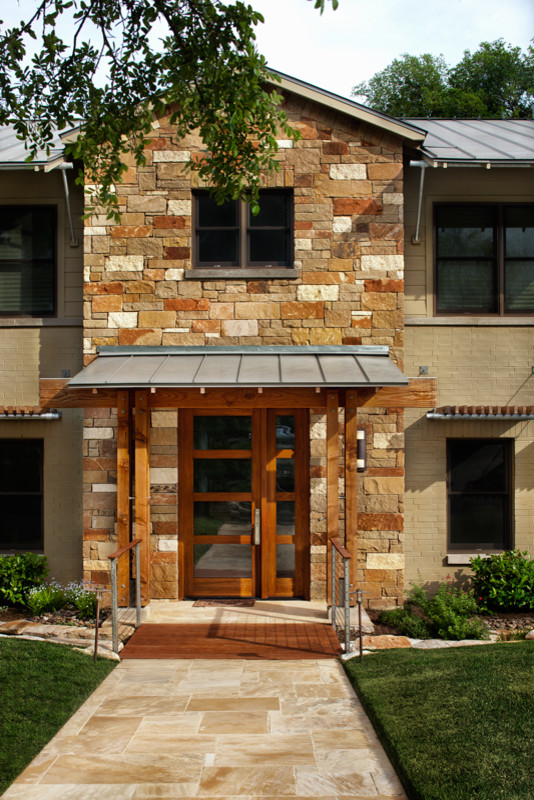 Design ideas for a large contemporary two floor house exterior in Austin with stone cladding.