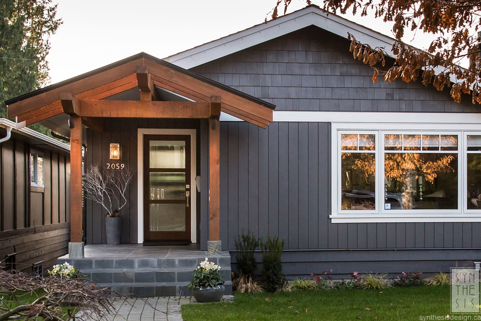Photo of a medium sized and gey contemporary two floor detached house in Vancouver with wood cladding.