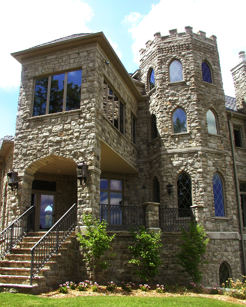 Huge tuscan beige three-story stone exterior home photo in Cedar Rapids