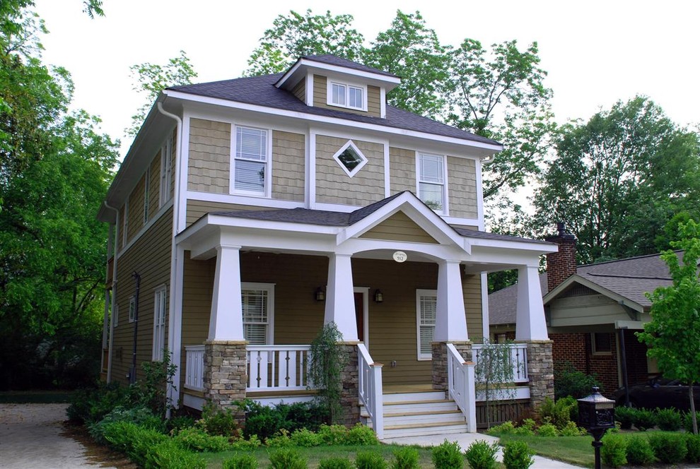 Photo of a medium sized traditional two floor house exterior in Atlanta with wood cladding and a hip roof.