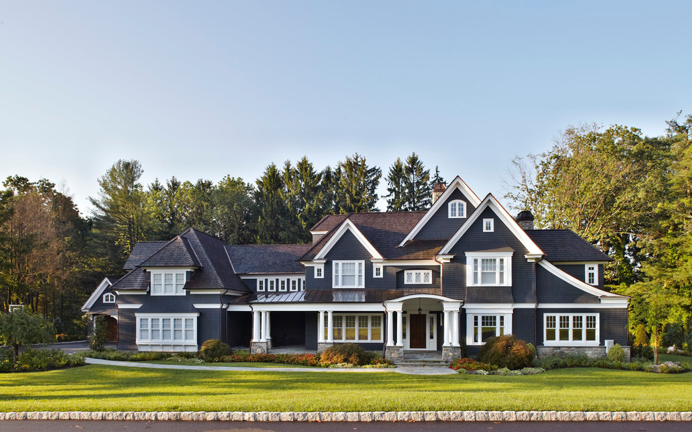 Large elegant black three-story gable roof photo in New York