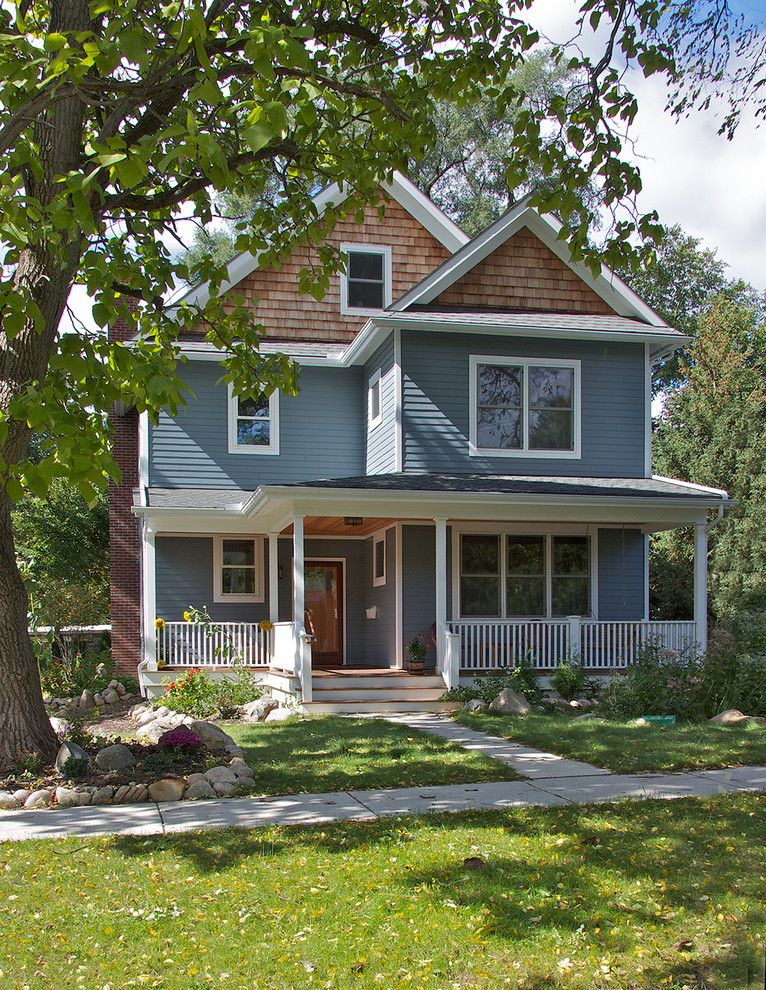 Example of a mid-sized classic blue two-story concrete fiberboard exterior home design in Detroit with a shingle roof