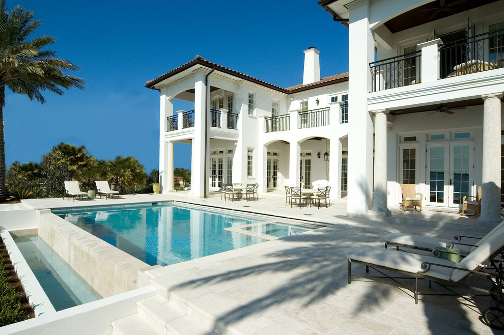 Huge coastal white two-story stucco exterior home idea in Miami with a hip roof