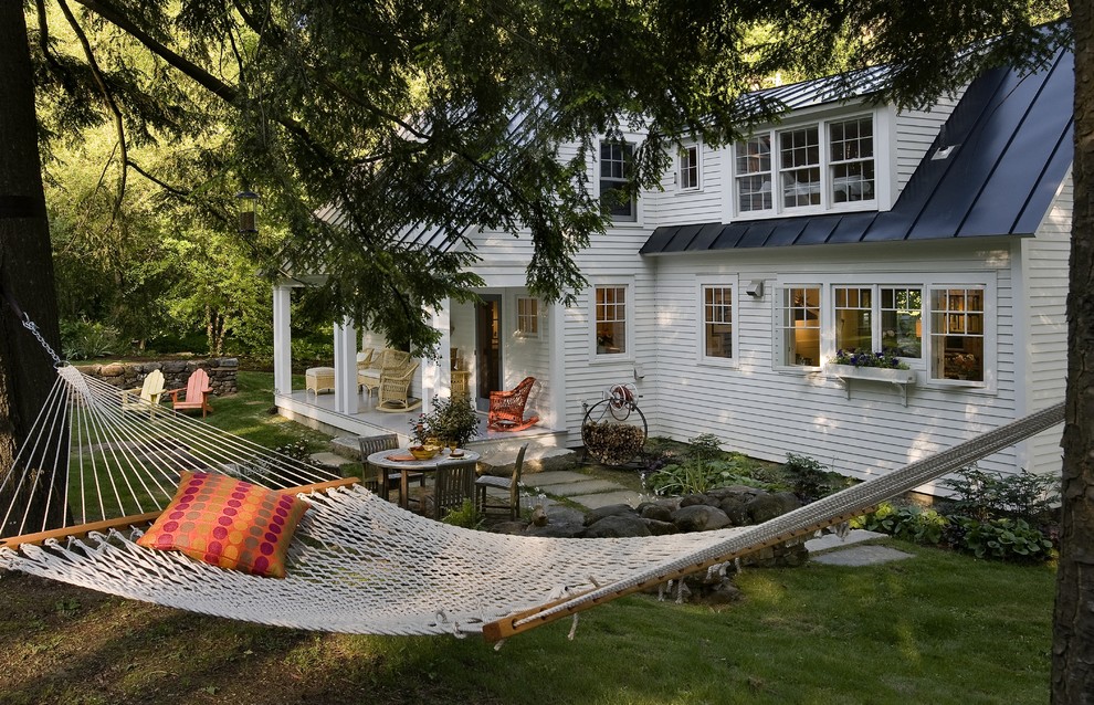 Example of a classic two-story wood exterior home design in Burlington