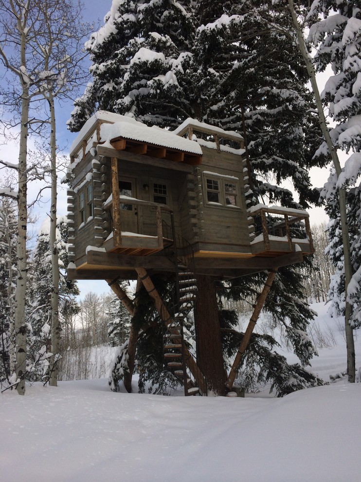 Inspiration for a rustic house exterior in Denver with wood cladding.