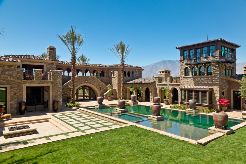 This is an example of a mediterranean house exterior in Orange County with stone cladding.