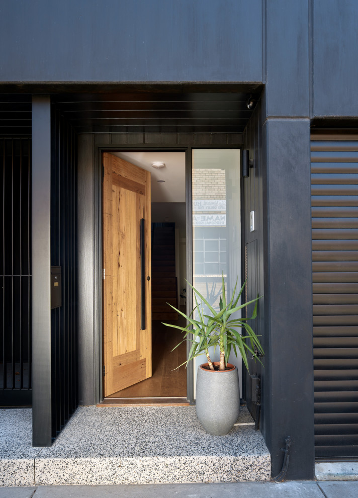 Large contemporary black three-story wood townhouse exterior idea in Melbourne