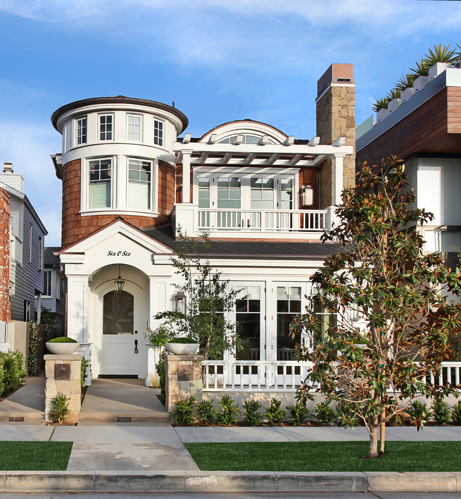 Example of a beach style three-story exterior home design in Orange County