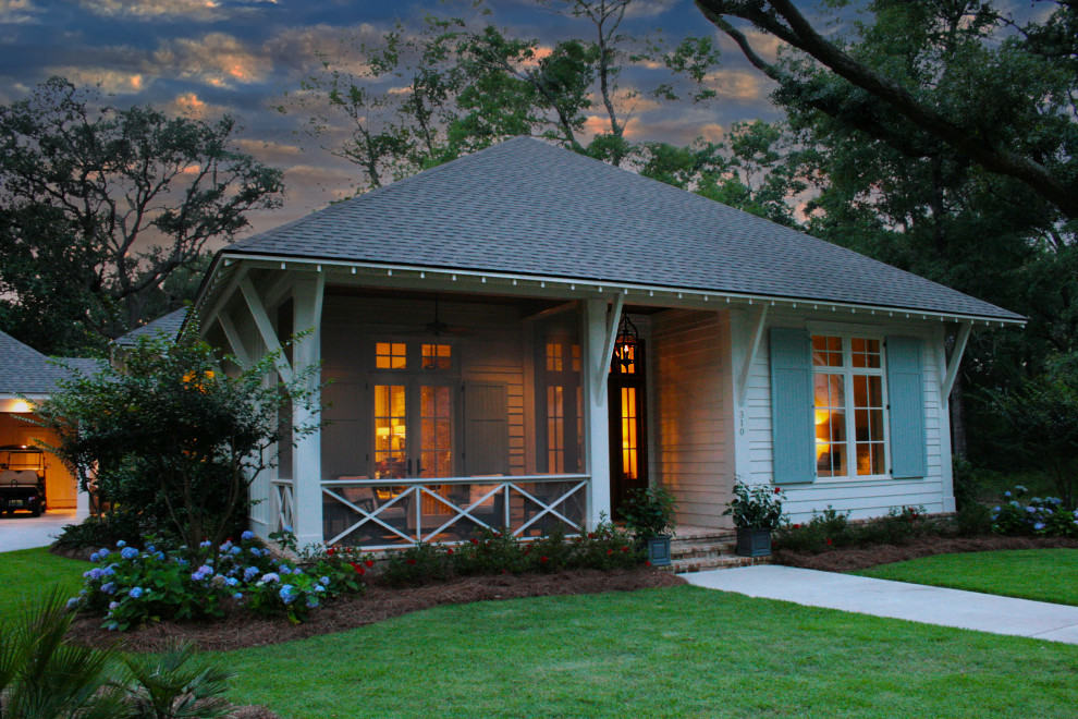 Example of a blue exterior home design with a hip roof and a shingle roof