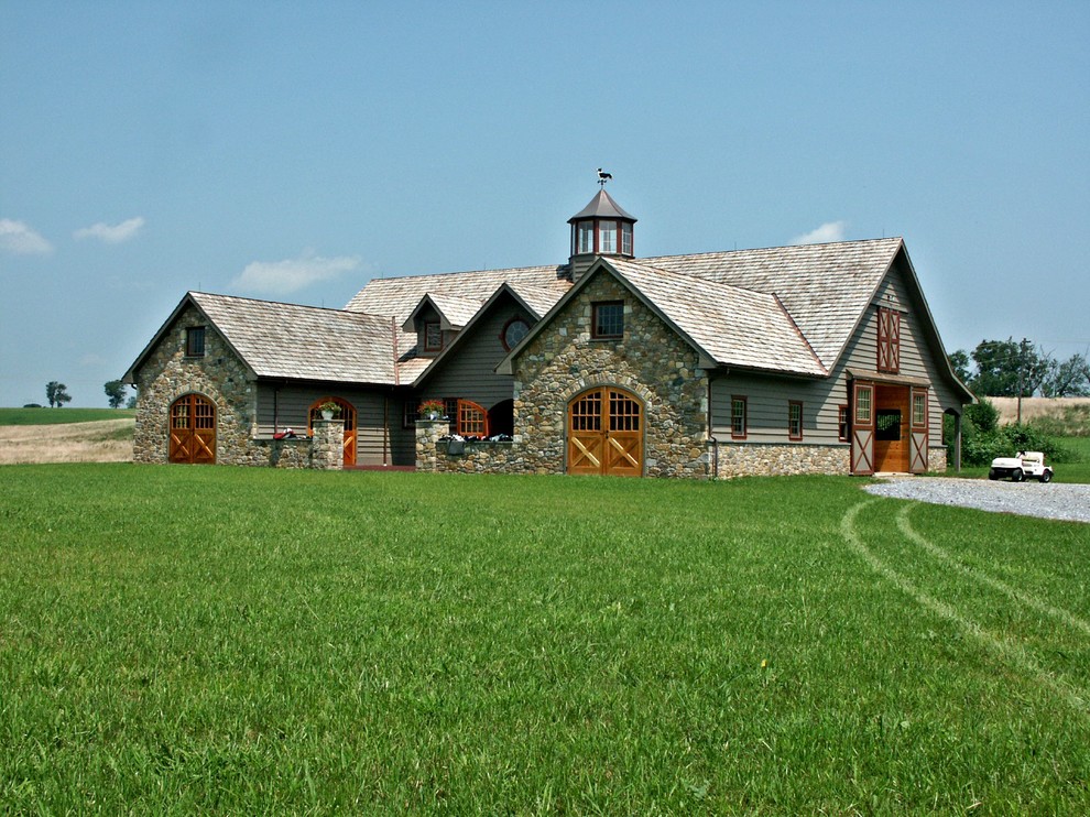 Réalisation d'une façade de maison grise champêtre de taille moyenne et à un étage avec un toit à deux pans et un revêtement mixte.
