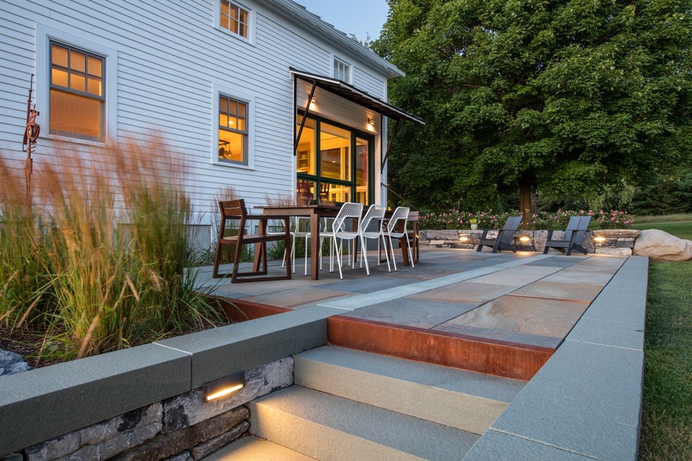 Mid-sized cottage white two-story wood exterior home photo in Burlington with a metal roof