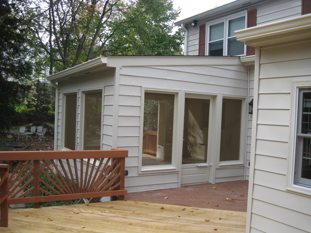 White classic two floor house exterior in DC Metro with vinyl cladding and a hip roof.