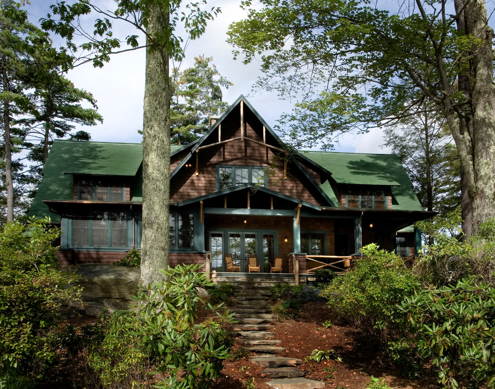Large mountain style brown two-story wood gable roof photo in New York