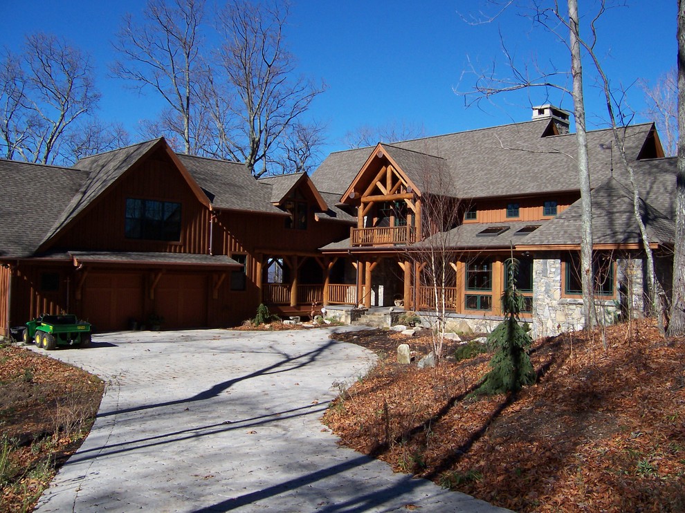 На фото: большой, трехэтажный, деревянный, коричневый частный загородный дом в стиле рустика с двускатной крышей и крышей из гибкой черепицы