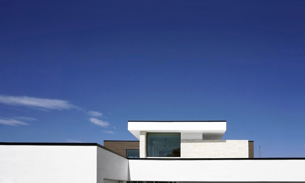 Inspiration for a large 1960s white two-story stucco exterior home remodel in Orange County