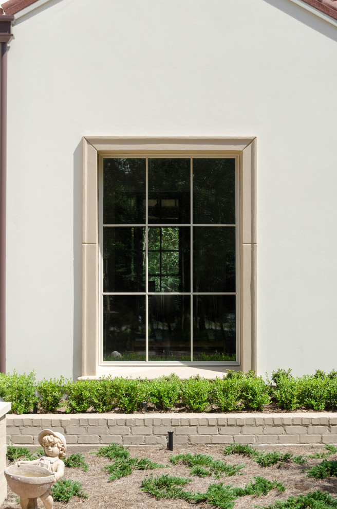 Inspiration for a large mediterranean white two-story stucco exterior home remodel in New Orleans