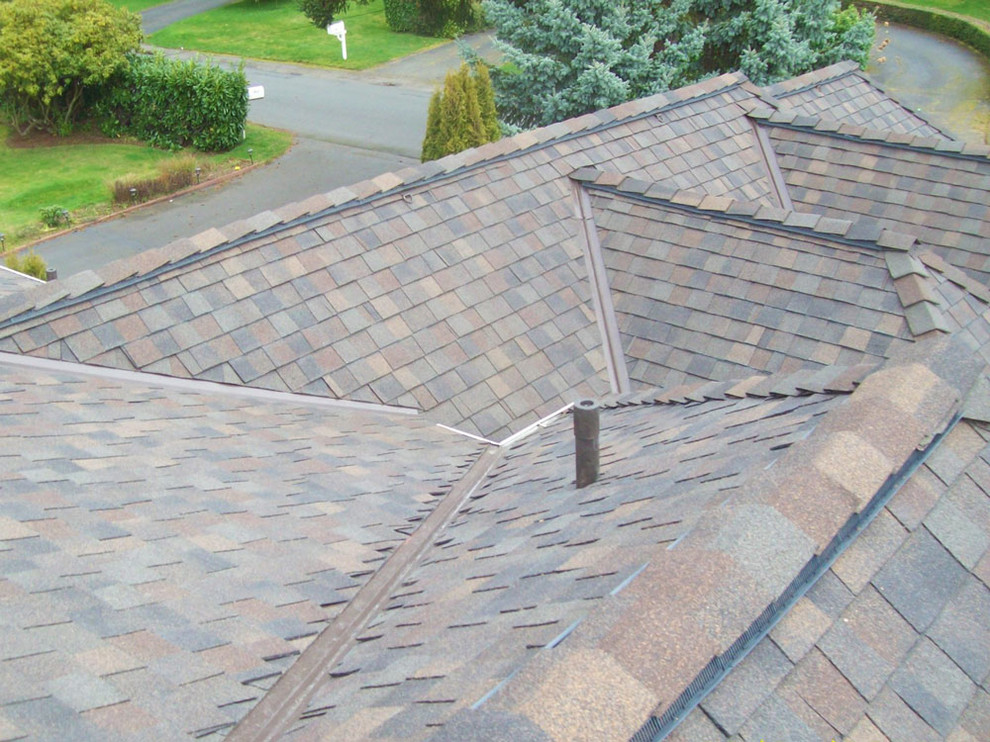 Photo of a large and beige traditional two floor detached house in Seattle with a hip roof and a shingle roof.