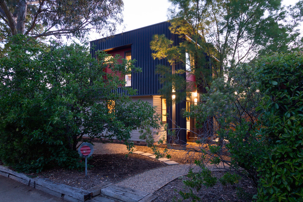 Photo of a small and blue contemporary two floor house exterior in Canberra - Queanbeyan with metal cladding and a flat roof.