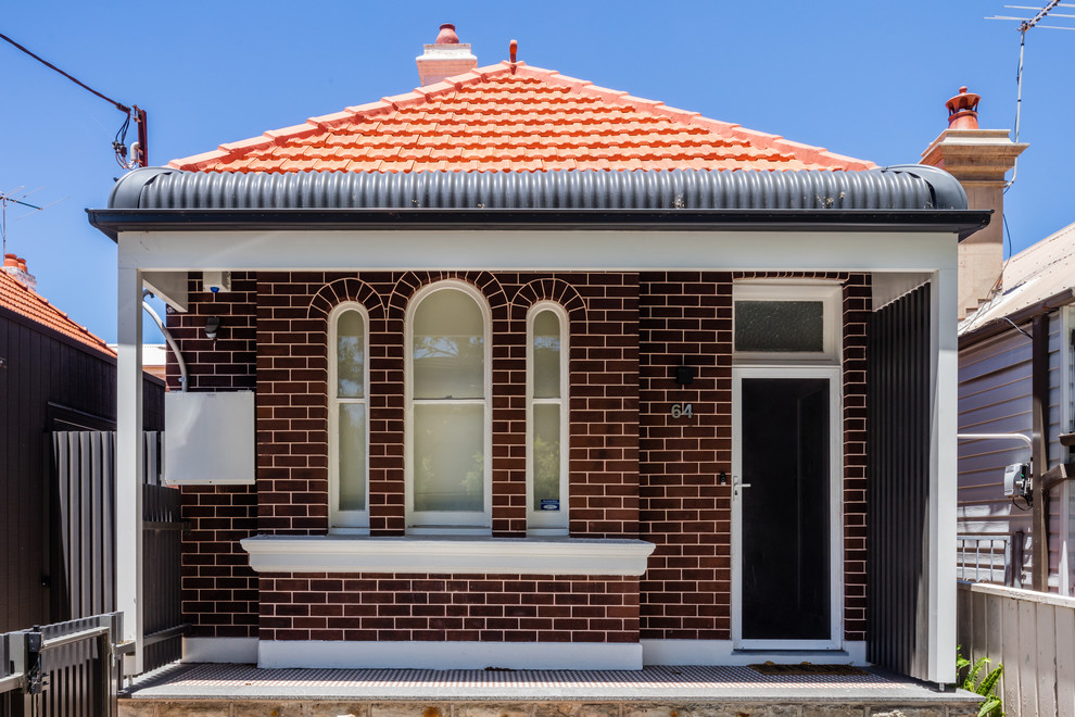 Modelo de fachada de casa roja clásica renovada de una planta con revestimiento de ladrillo, tejado a cuatro aguas y tejado de teja de barro