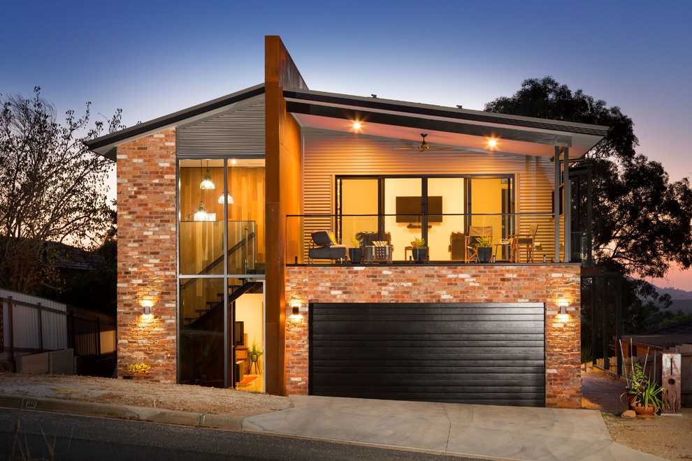 Свежая идея для дизайна: двухэтажный, кирпичный, красный частный загородный дом в современном стиле с двускатной крышей - отличное фото интерьера