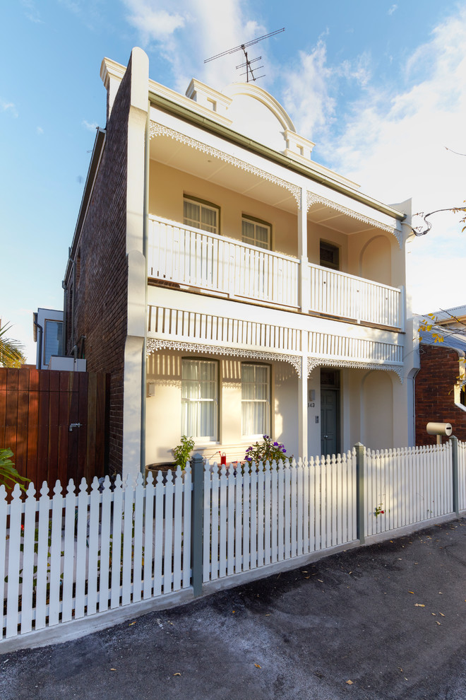 Inspiration for a medium sized and yellow classic two floor brick house exterior in Sydney.