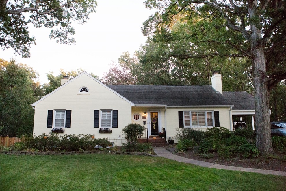 Design ideas for a medium sized and yellow retro two floor brick house exterior in DC Metro with a pitched roof.