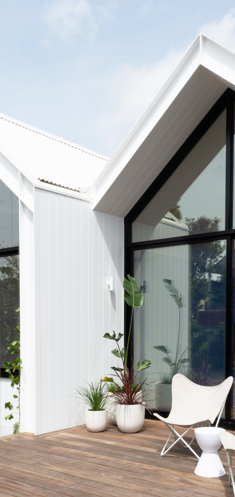 Inspiration for a small and white scandi bungalow detached house in Melbourne with concrete fibreboard cladding, a pitched roof and a metal roof.