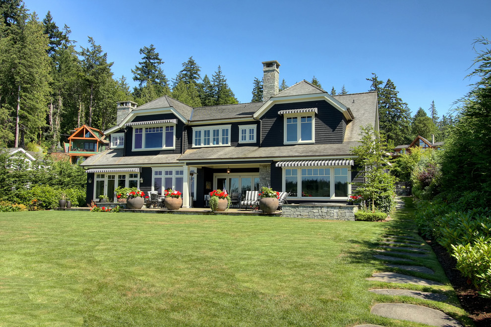 Inspiration for a timeless black two-story wood exterior home remodel in Seattle with a clipped gable roof