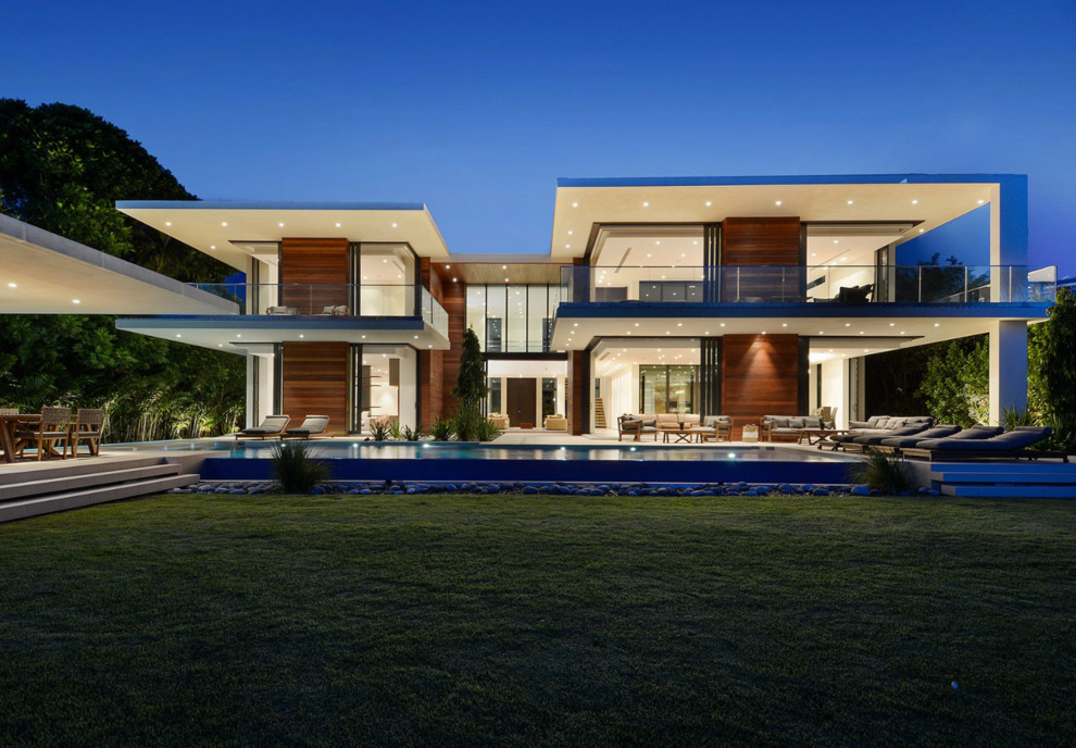 Inspiration for a contemporary two-story wood flat roof remodel in Miami