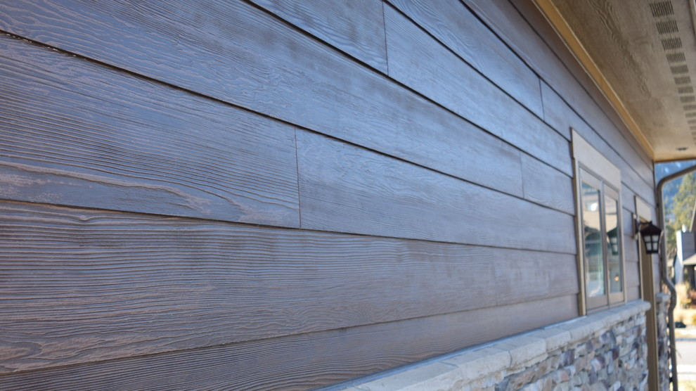 Photo of a brown rustic house exterior in Other with concrete fibreboard cladding.
