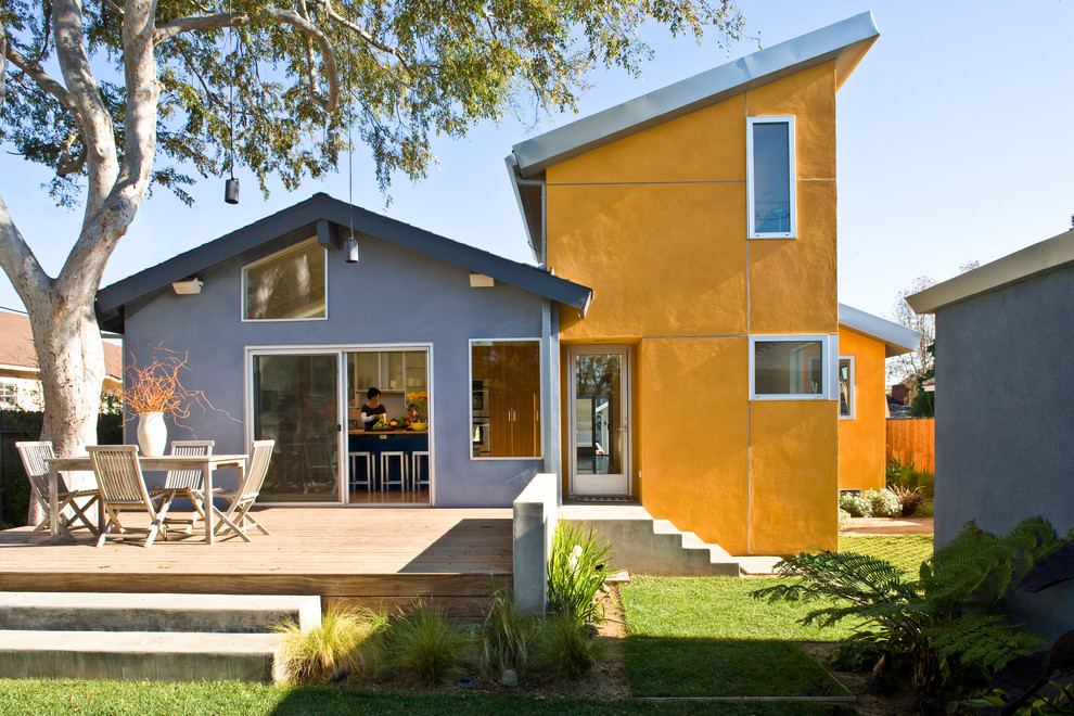 На фото: двухэтажный, разноцветный частный загородный дом среднего размера в современном стиле с облицовкой из цементной штукатурки и односкатной крышей