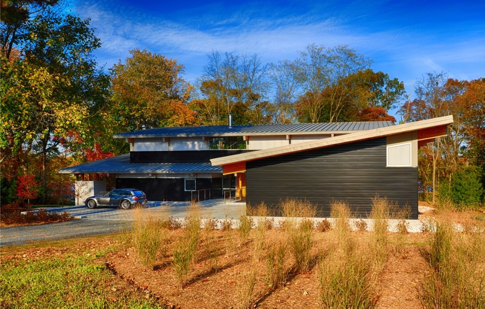Large minimalist black three-story metal exterior home photo in Baltimore with a shed roof