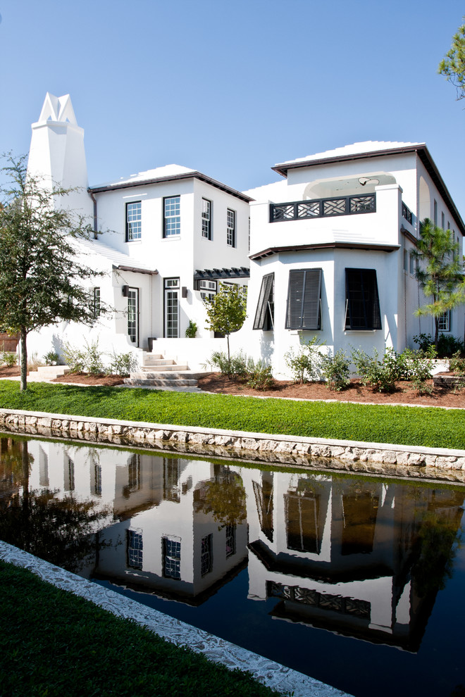 Example of a minimalist white exterior home design in Miami