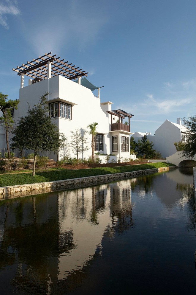 Design ideas for a white mediterranean two floor house exterior in Miami.