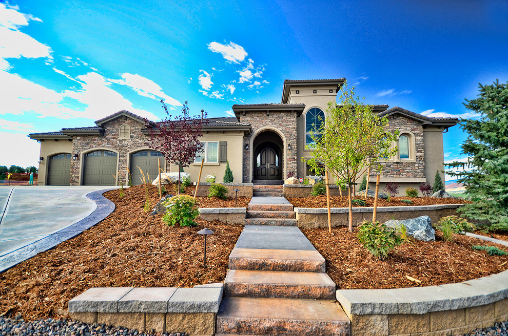 Inspiration for a mid-sized transitional beige two-story stone exterior home remodel in Denver